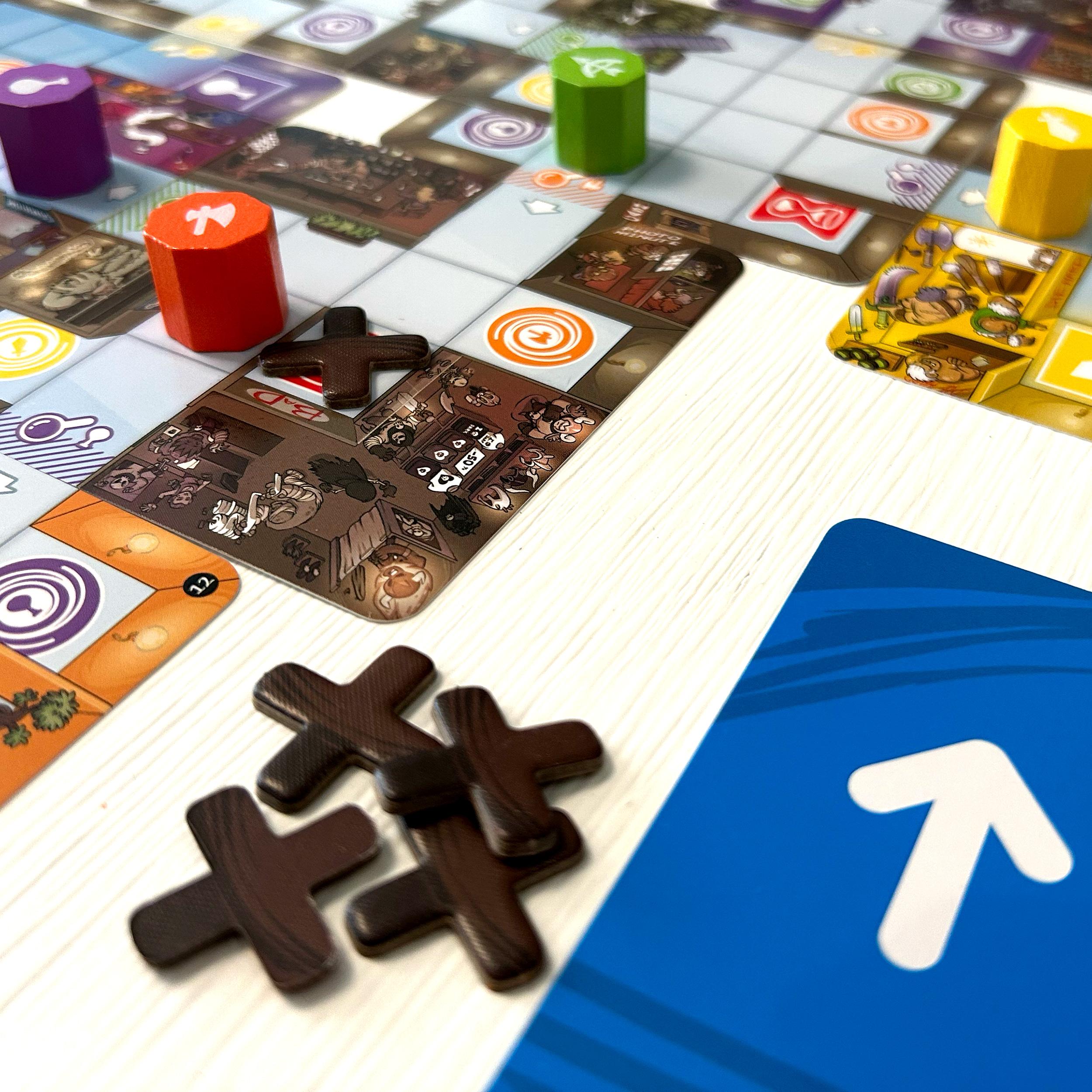 Magic Maze board showing several heroes, unused Out of Order tokens, and a direction arrow card beside the board.