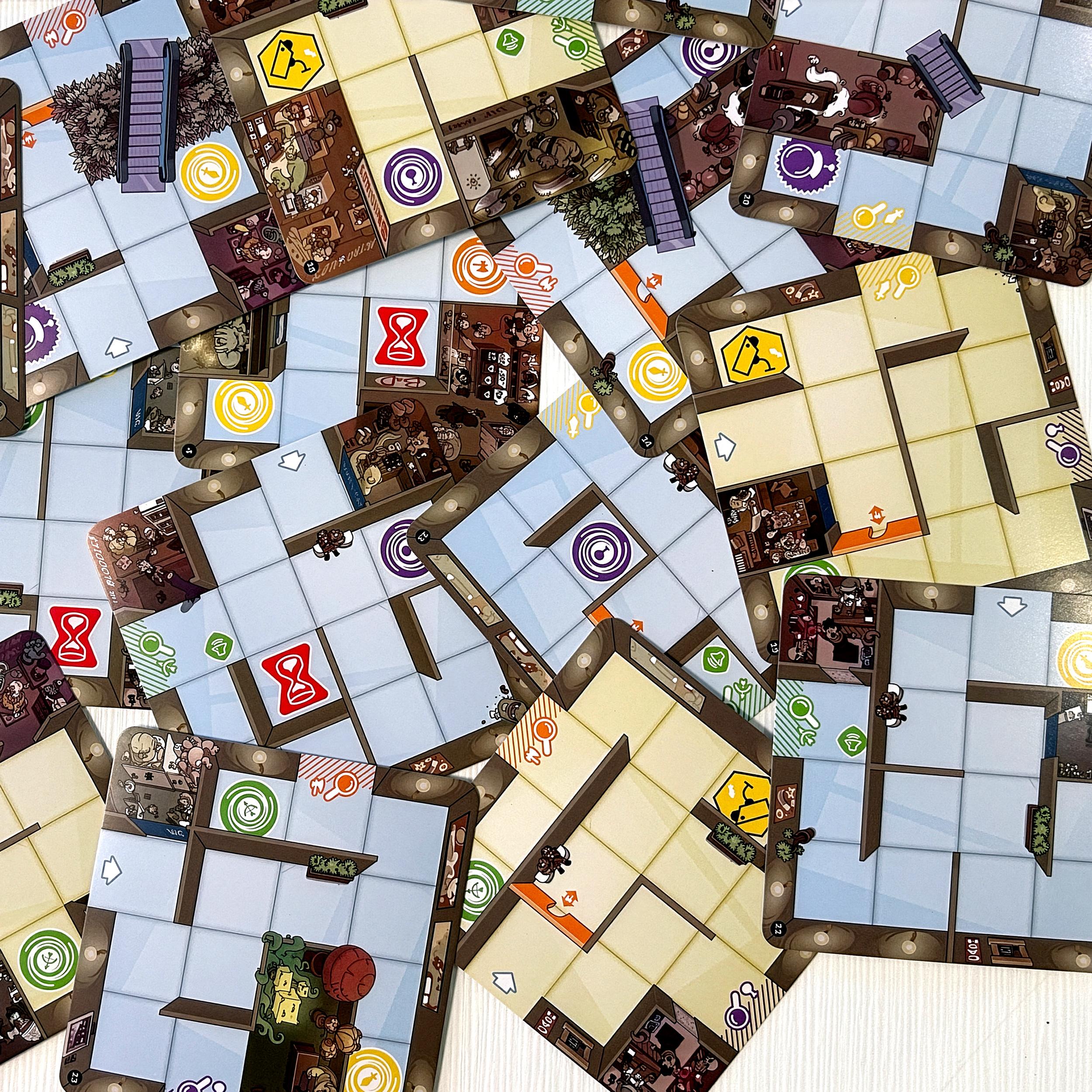 Loose Magic Maze mall tiles scattered on a table, showing corridors, walls, and special spaces without connections.