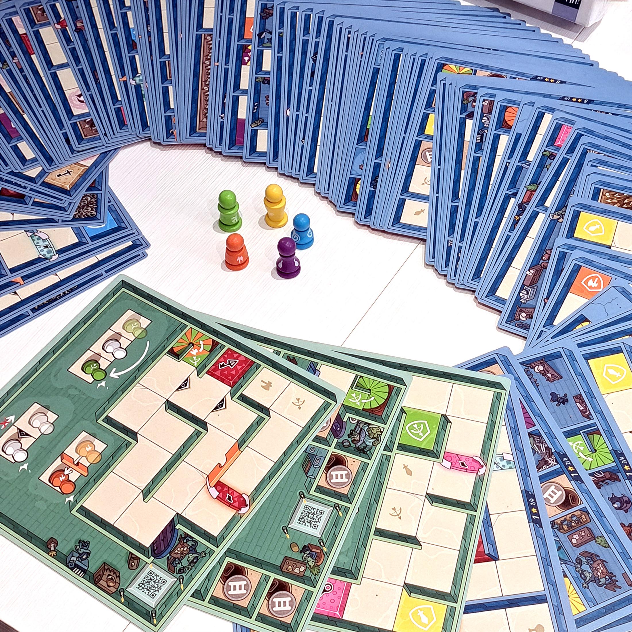 Many maze tiles spread out with colored pawns grouped in the center on a table.