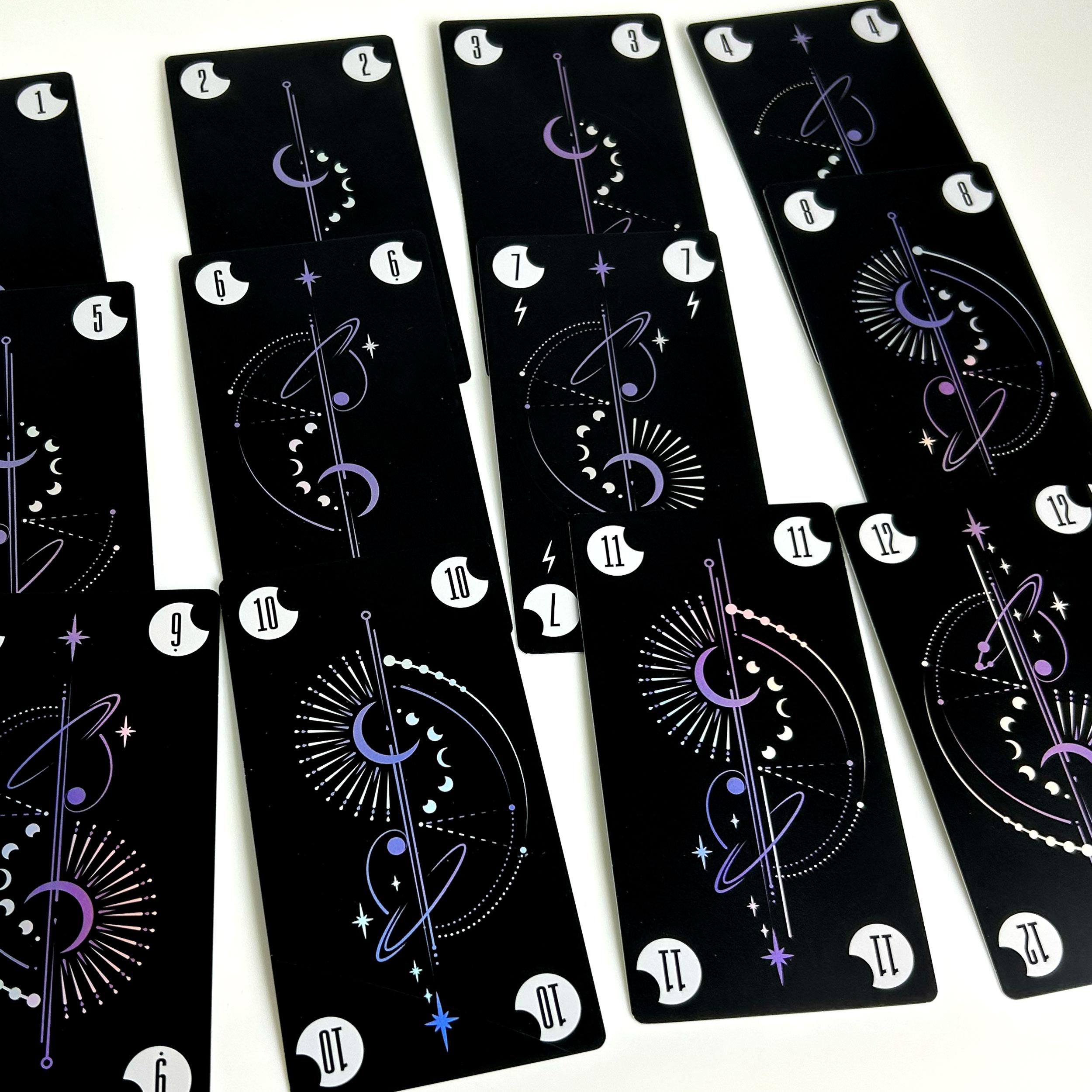 White suit number cards laid out, showing values from 1 to 12 with a moon-themed graphic design.
